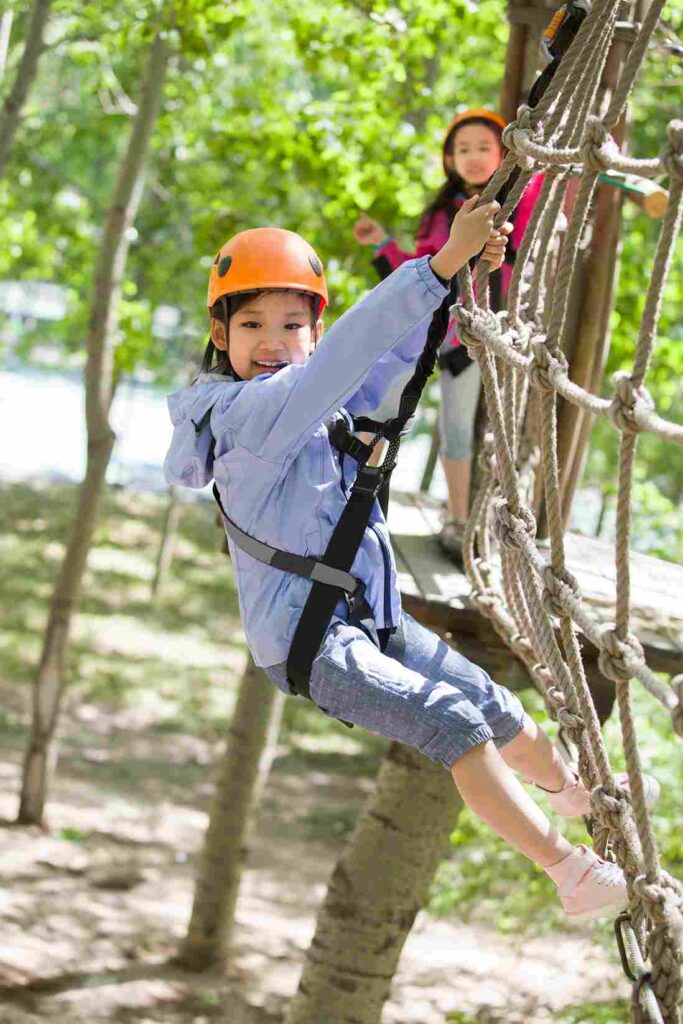 happy-children-playing-in-tree-top-adventure-park_