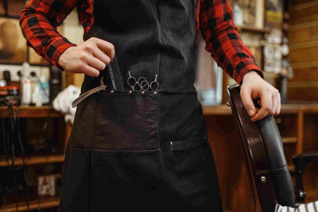 barber-in-apron-with-cutting-tools-barbershop_