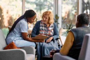 senior woman and care giver going over medical record in a senior care centre
